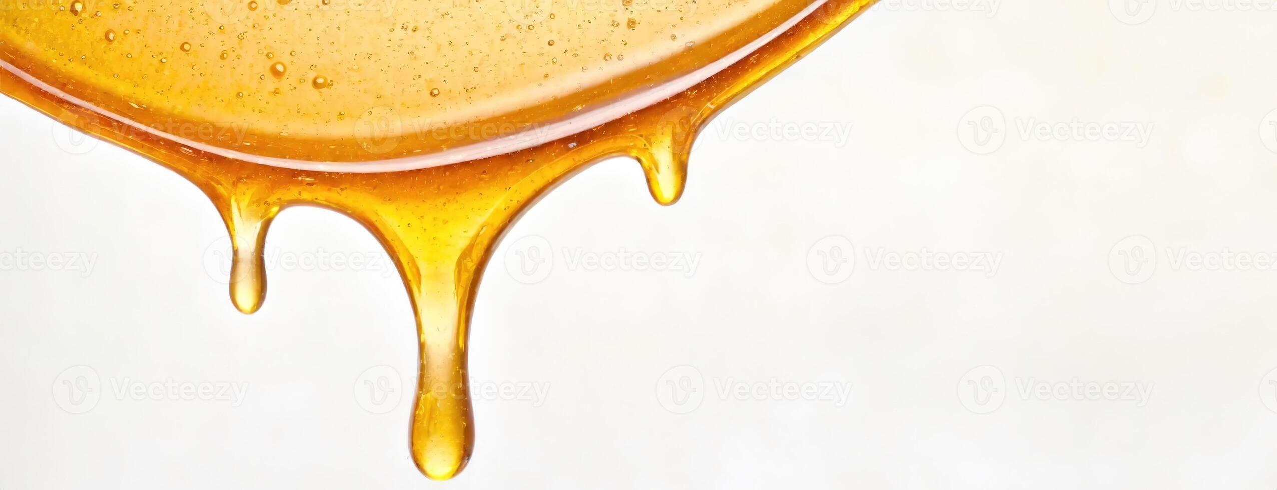 AI Generated Close-Up of Honey. Amber Essence Dripping Down. Glistening droplets poised to fall, embodying sweetness. White background. Panorama with copy space. photo