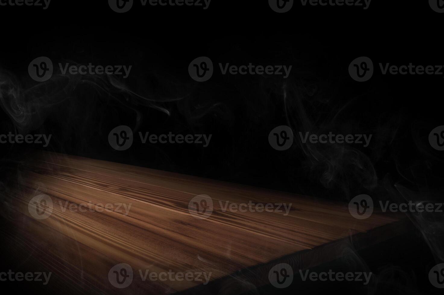 empty wooden table with smoke float up on dark background Empty Space for display your products. photo