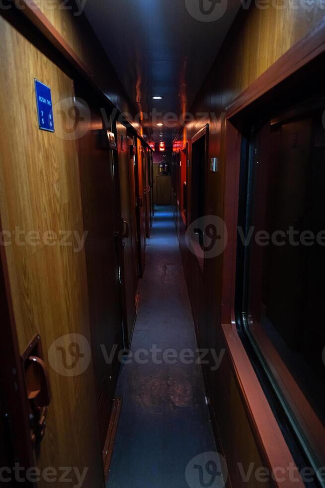 Empty hallway in old sleeping wagon of train at night. photo
