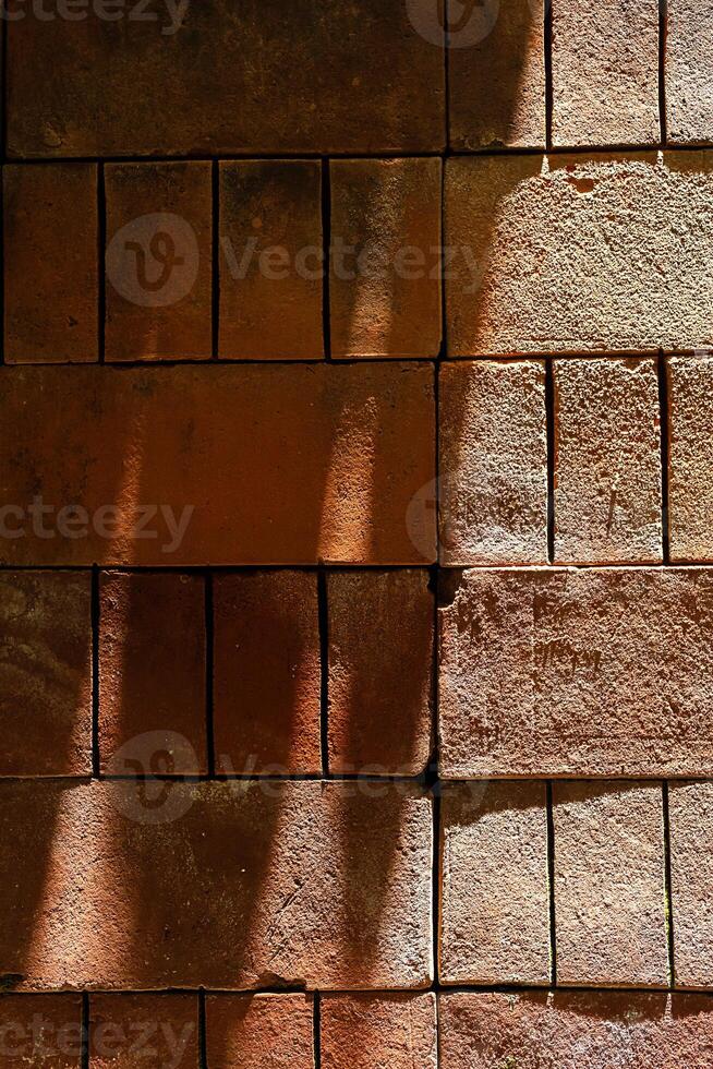 Patterns made from light and shadows on brick wall. photo