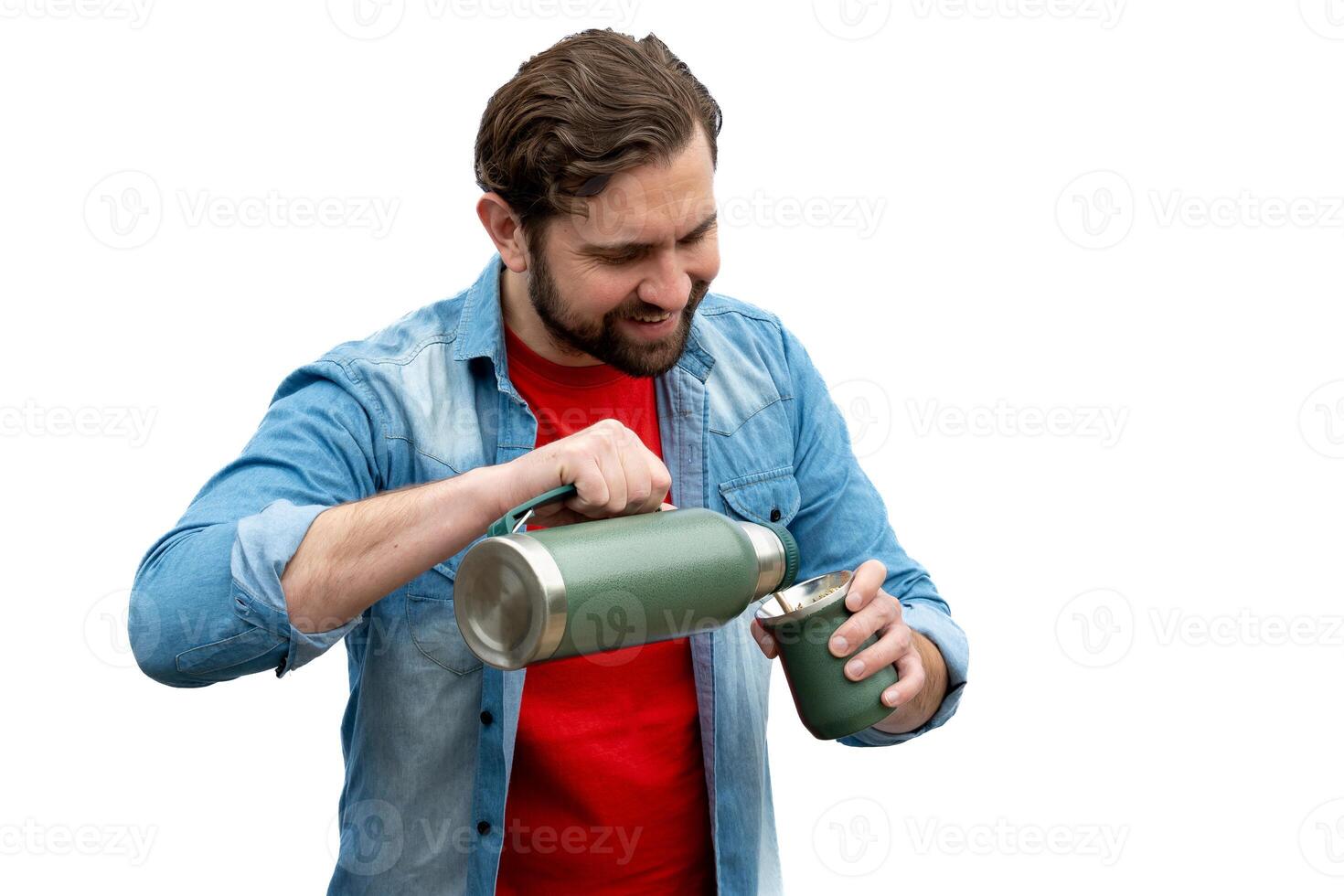 Young man sipping a mate, he is dressed casually and very happy. On an isolated white background. photo