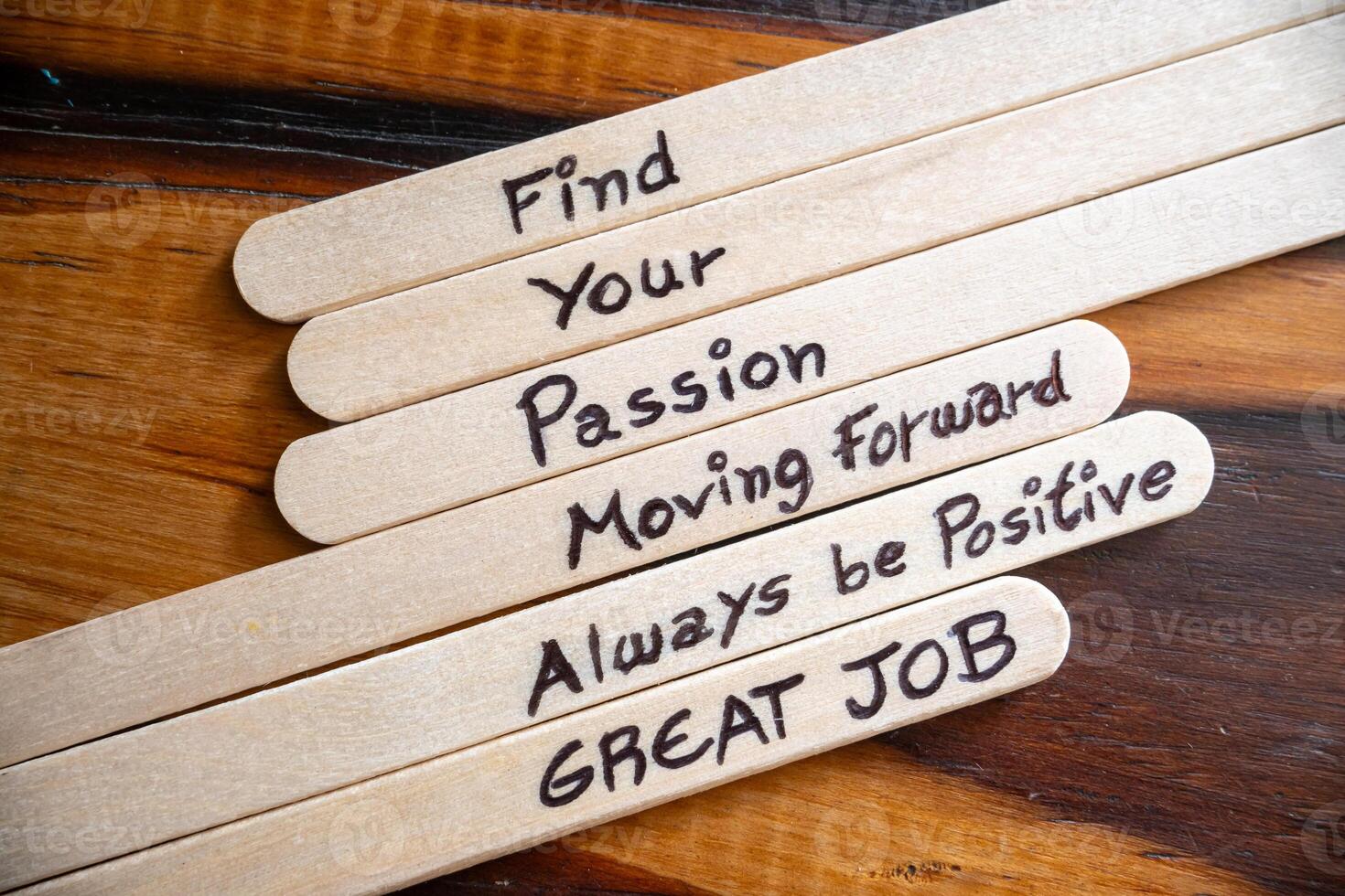 Concept of motivational words on ice cream sticks on a table. photo