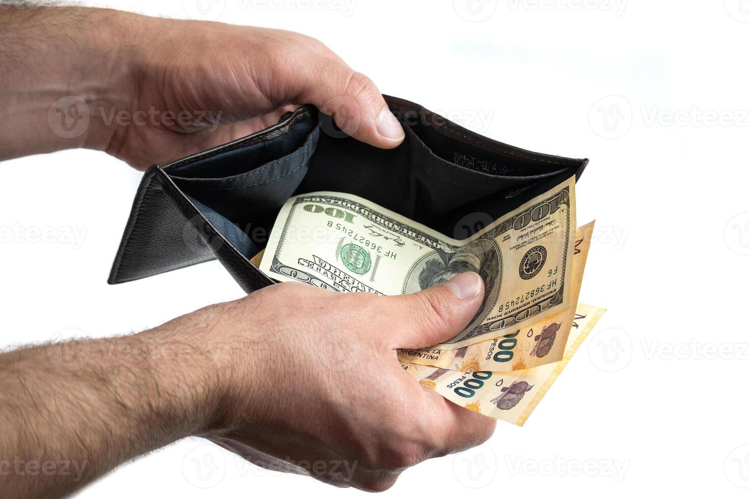 Hand with wallet showing dollar bill and Argentine peso bills photo