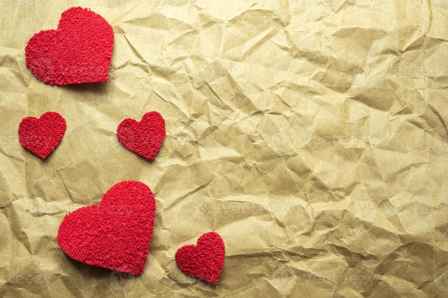 Hearts on a crumpled wooden paper. photo