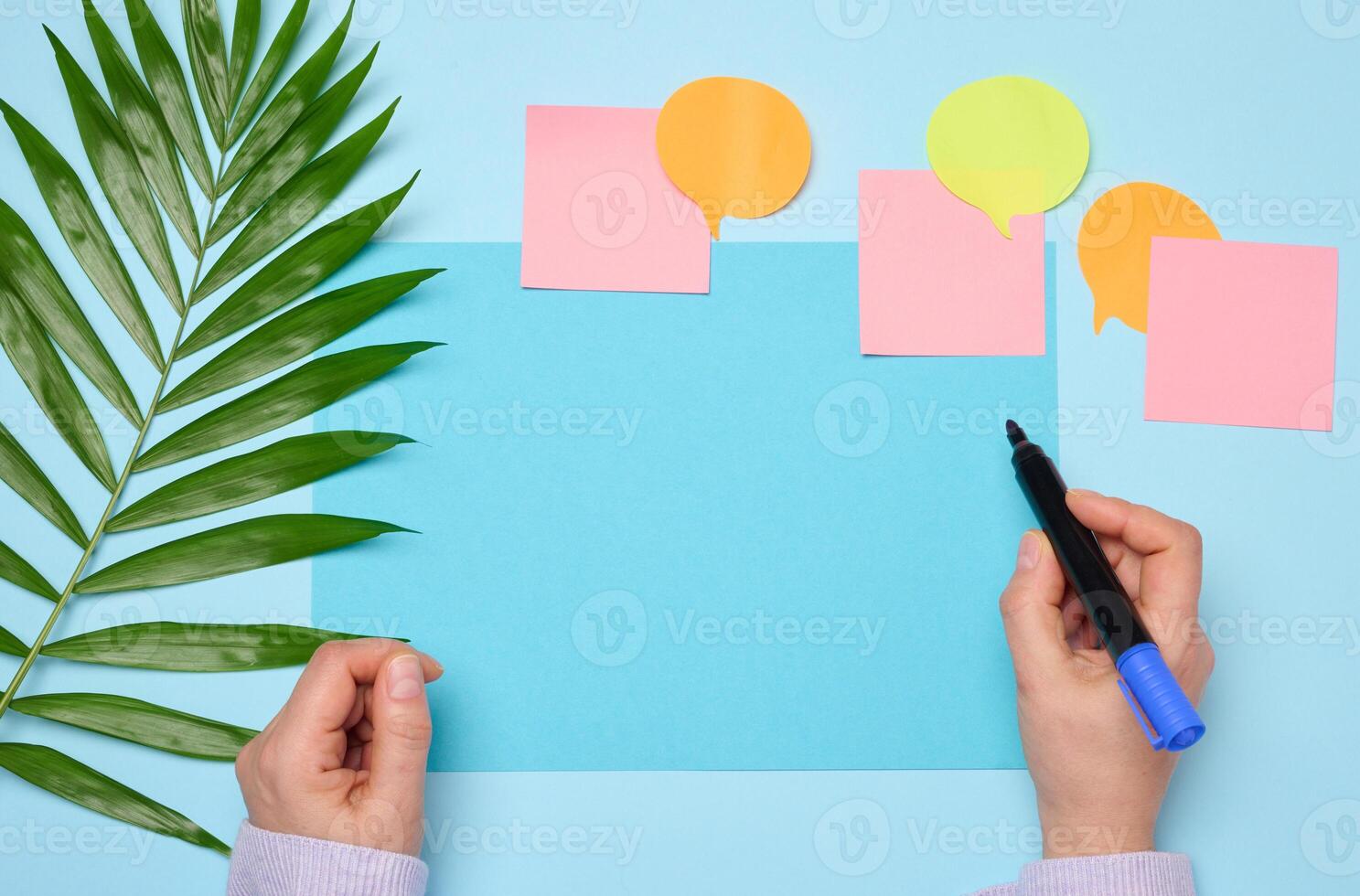 Blank rectangular sheet of paper on a blue background photo