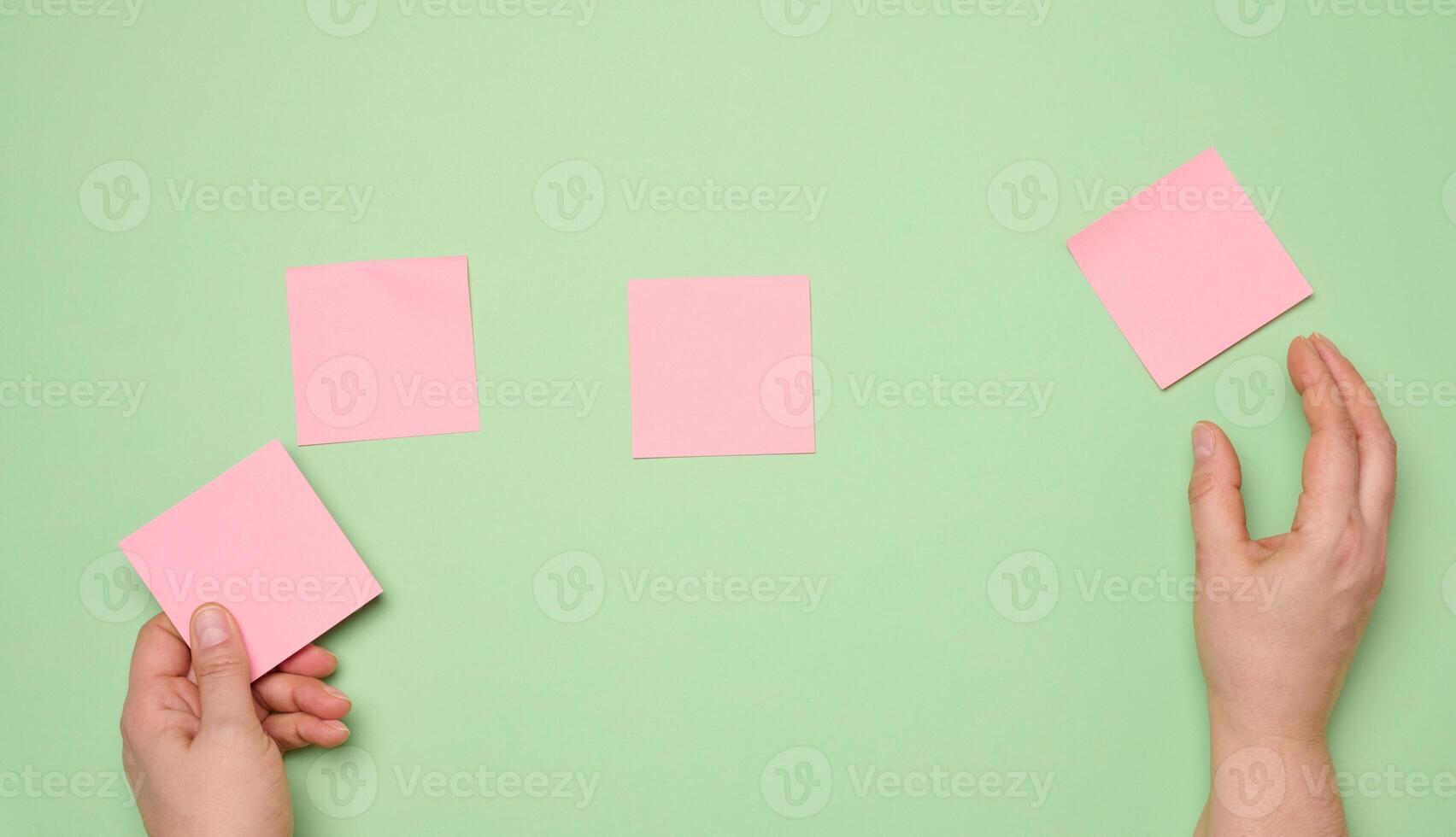 Blank square stickers on green background photo