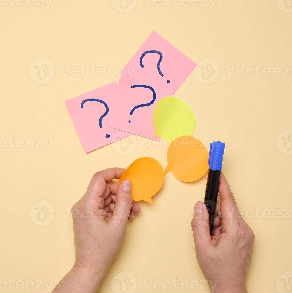 Paper stickers with question marks on a yellow background photo