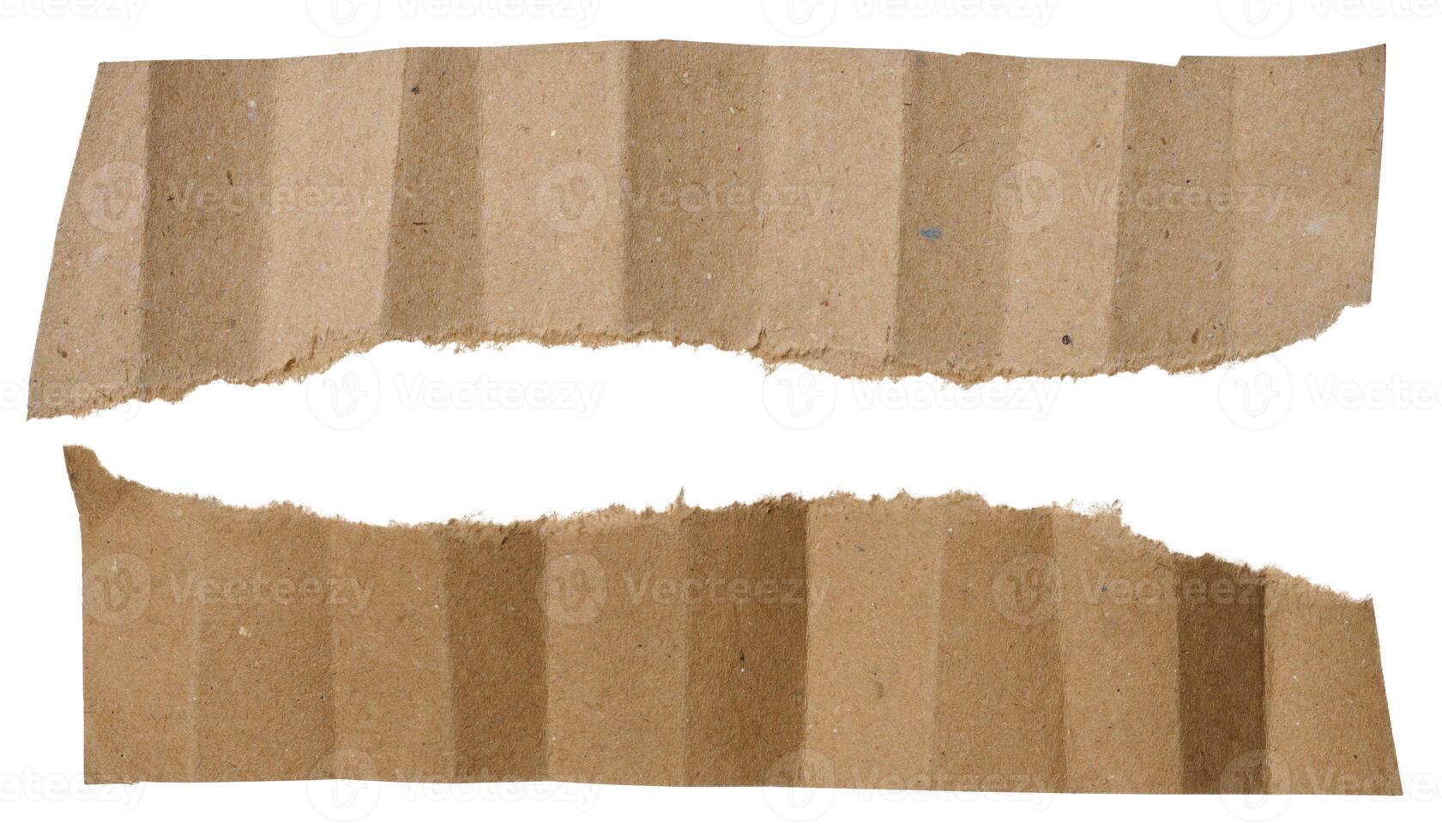 Piece of brown paper with torn edges isolated on background photo
