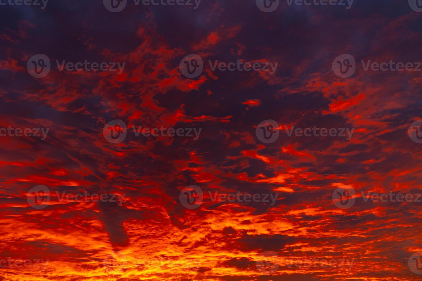 Dramatic sunset or sunrise view with orange and red clouds photo