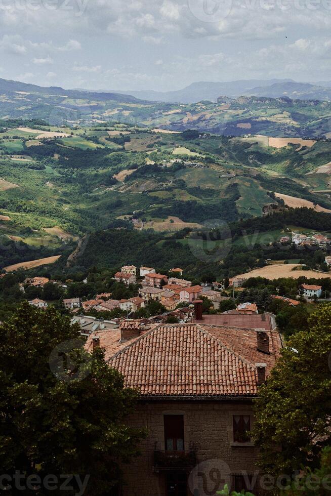 a breathtaking view from above of the houses and nature of San Marino photo