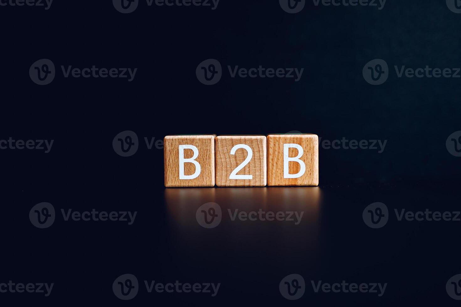 Wooden blocks form the text B2B against a black background. photo