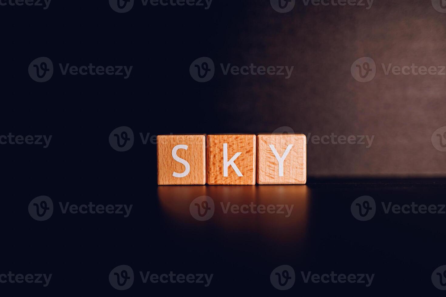 Wooden blocks form the text Sky against a black background. photo