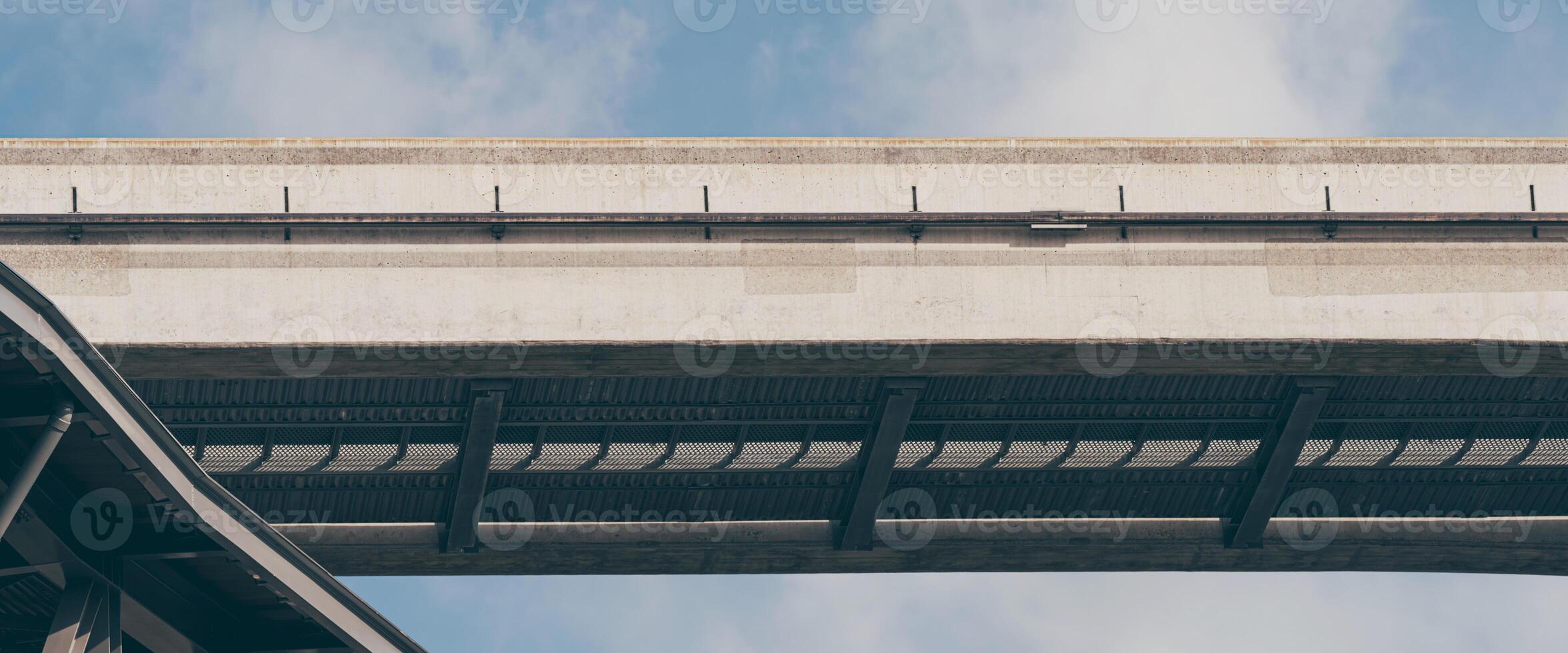 Minimalist shot of electric train tracks floating in the sky against a bright blue sky. photo