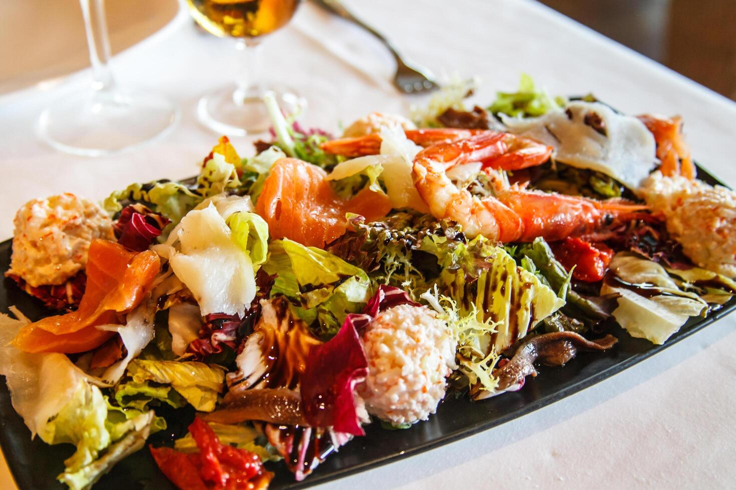 Salad with fish and seafood in the restaurant. photo