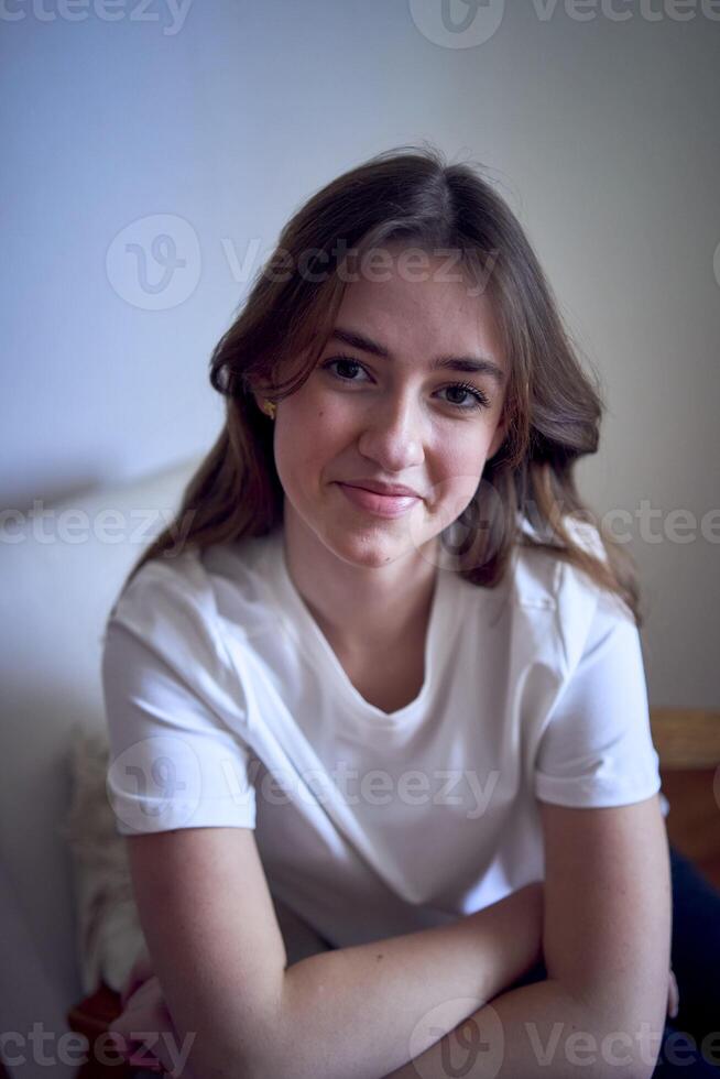 portrait of a beautiful teenage girl on a chair in a bright room in a minimalist style photo