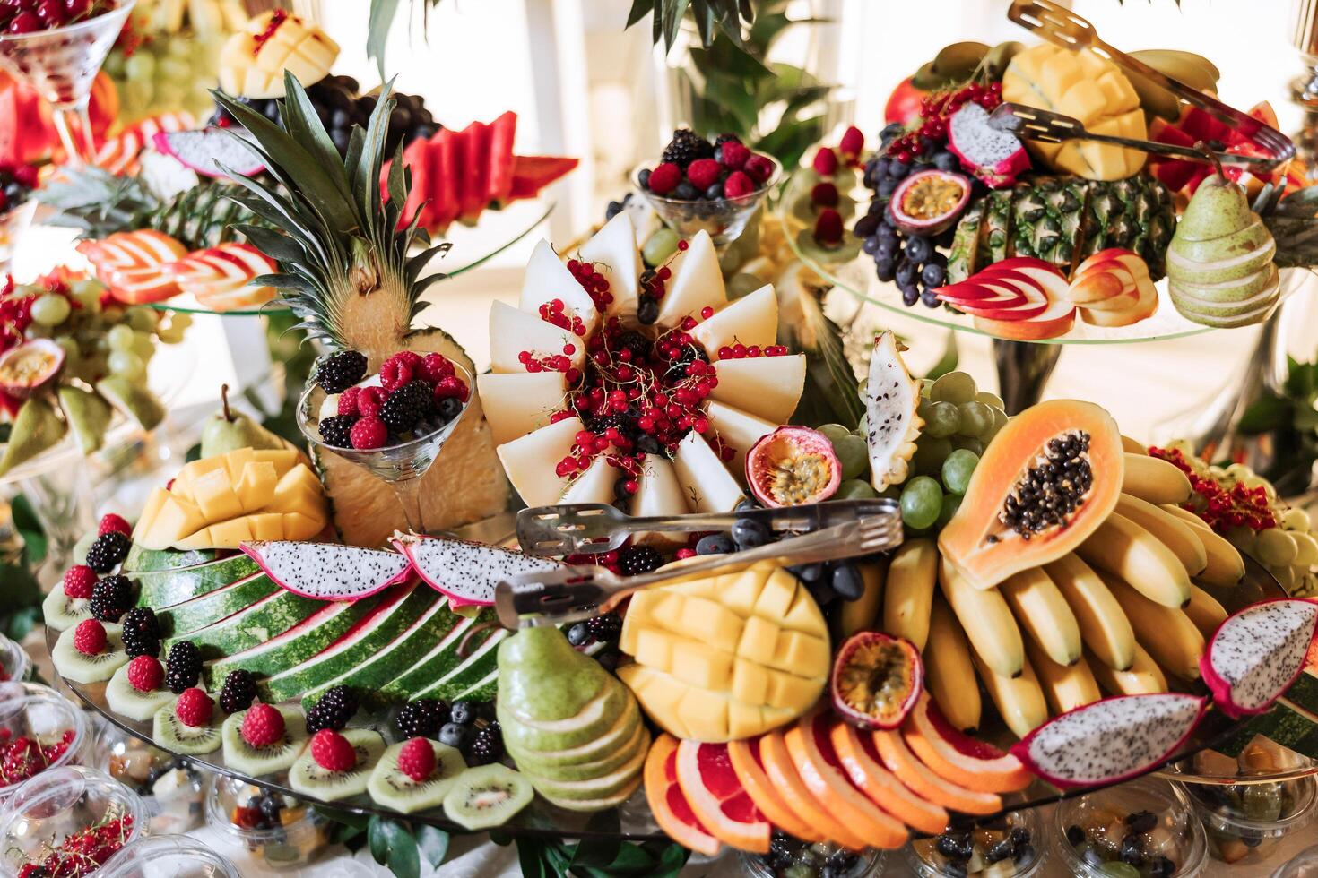 Fruit buffet for a wedding. Assortment of exotic fruits in the restaurant. Various compositions from fresh fruits. photo