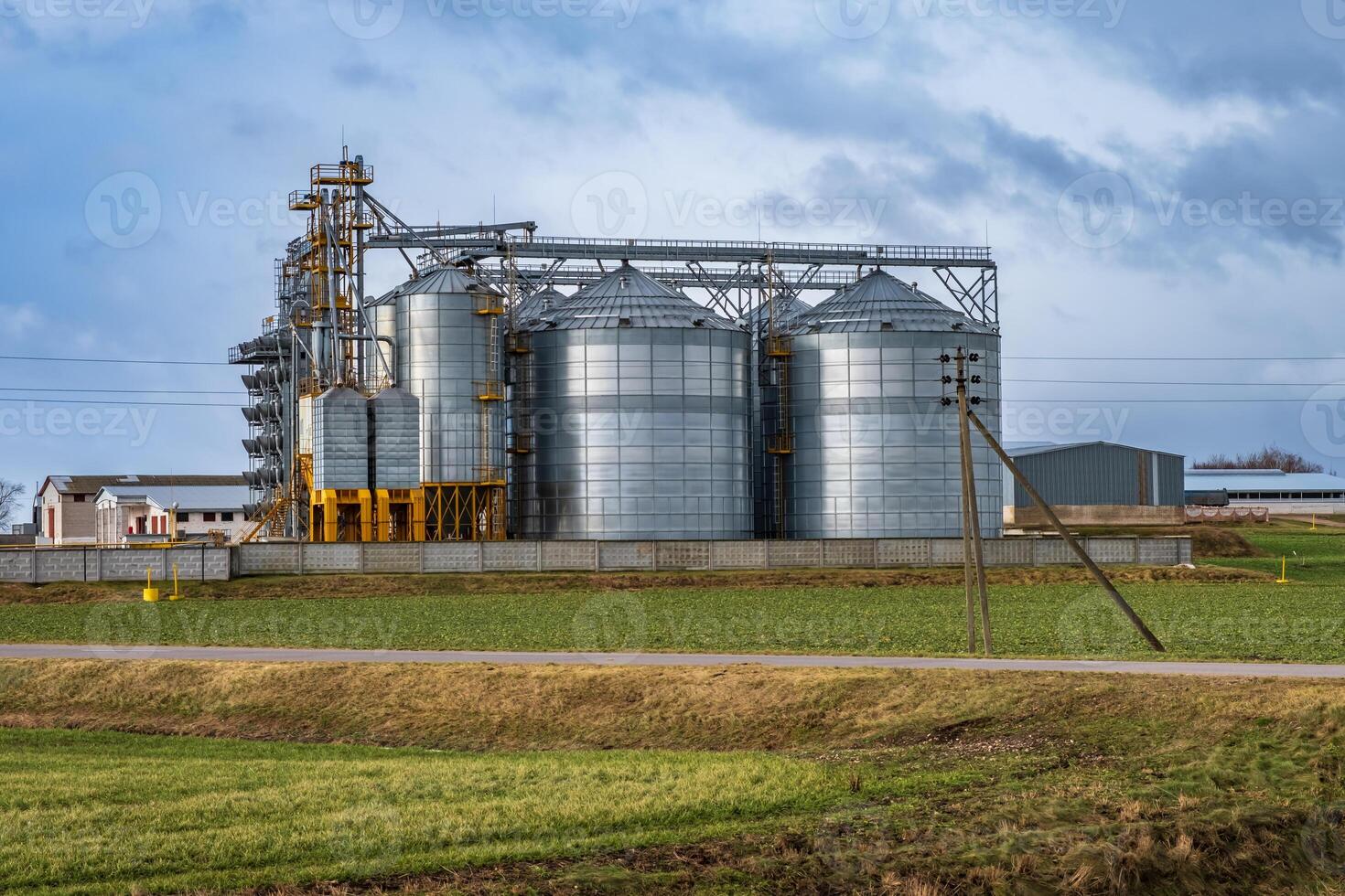 silos on agro-industrial complex with seed cleaning and drying line for grain storage photo