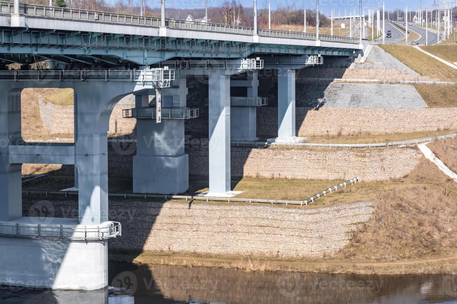 steel frame and concrete construction huge car bridge across the wide river photo