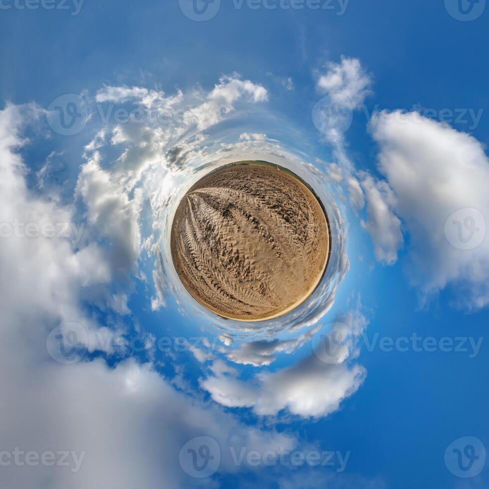 simple green tiny planet without buildings in blue sky with beautiful clouds. Transformation of spherical panorama 360 degrees. Spherical abstract aerial view. Curvature of space. photo