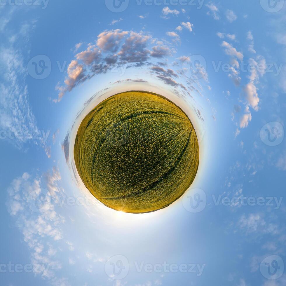 simple green tiny planet without buildings in blue sky with beautiful clouds. Transformation of spherical panorama 360 degrees. Spherical abstract aerial view. Curvature of space. photo