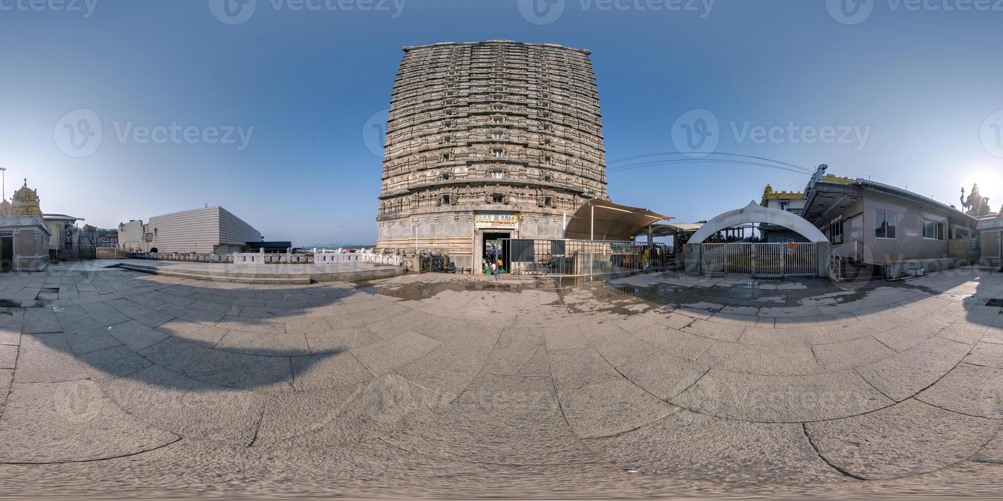 full 360 hdri panorama near tallest hindu shiva statue and castle tower gopuram in india on mountain near ocean in equirectangular spherical seamless projection photo