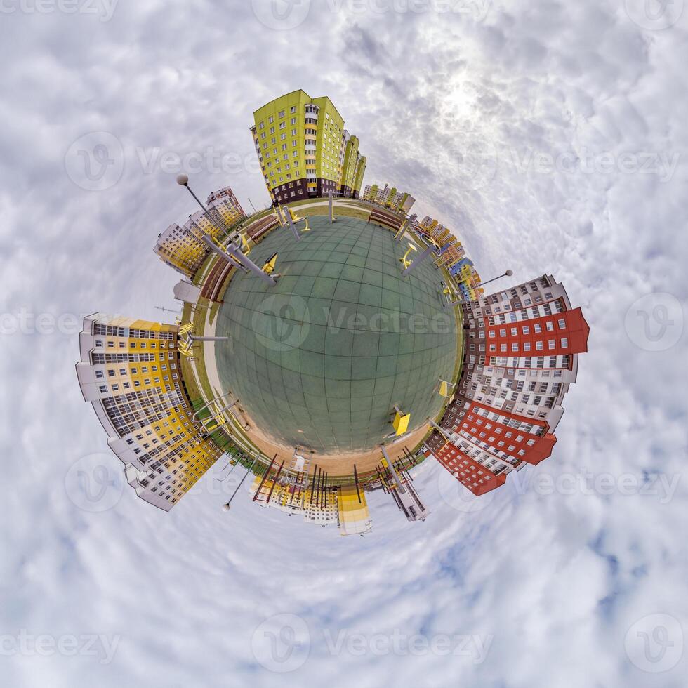 tiny planet in blue sky with clouds in city center near modern skyscrapers. Transformation of spherical 360 panorama in abstract aerial view. photo