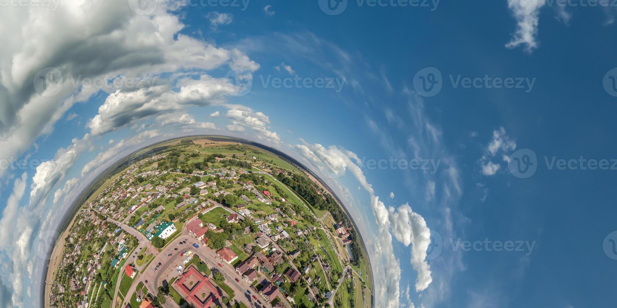 Aerial view from high altitude tiny planet in sky with clouds overlooking old town, urban development, buildings and crossroads. Transformation of spherical 360 panorama in abstract aerial view. photo
