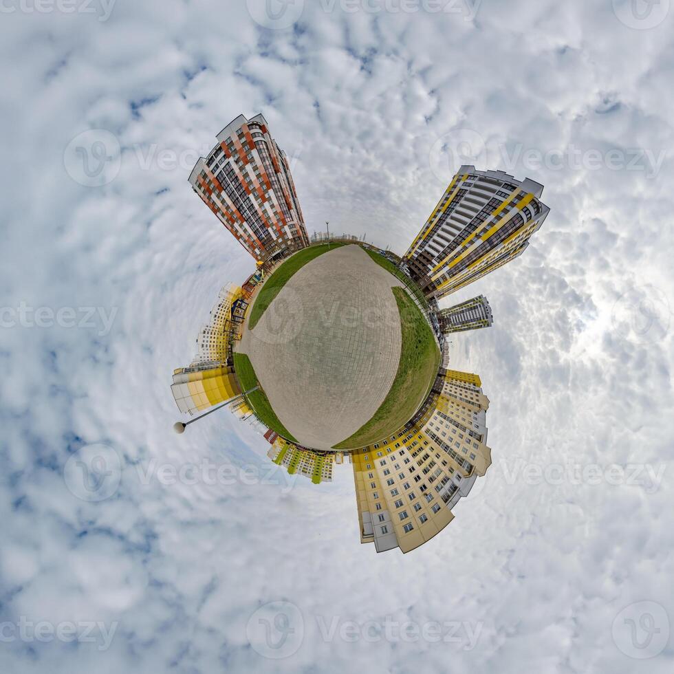 tiny planet in blue sky with clouds in city center near modern skyscrapers. Transformation of spherical 360 panorama in abstract aerial view. photo