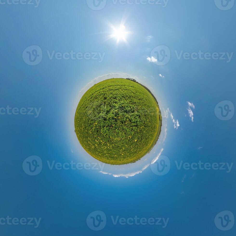 simple green tiny planet without buildings in blue sky with beautiful clouds. Transformation of spherical panorama 360 degrees. Spherical abstract aerial view. Curvature of space. photo