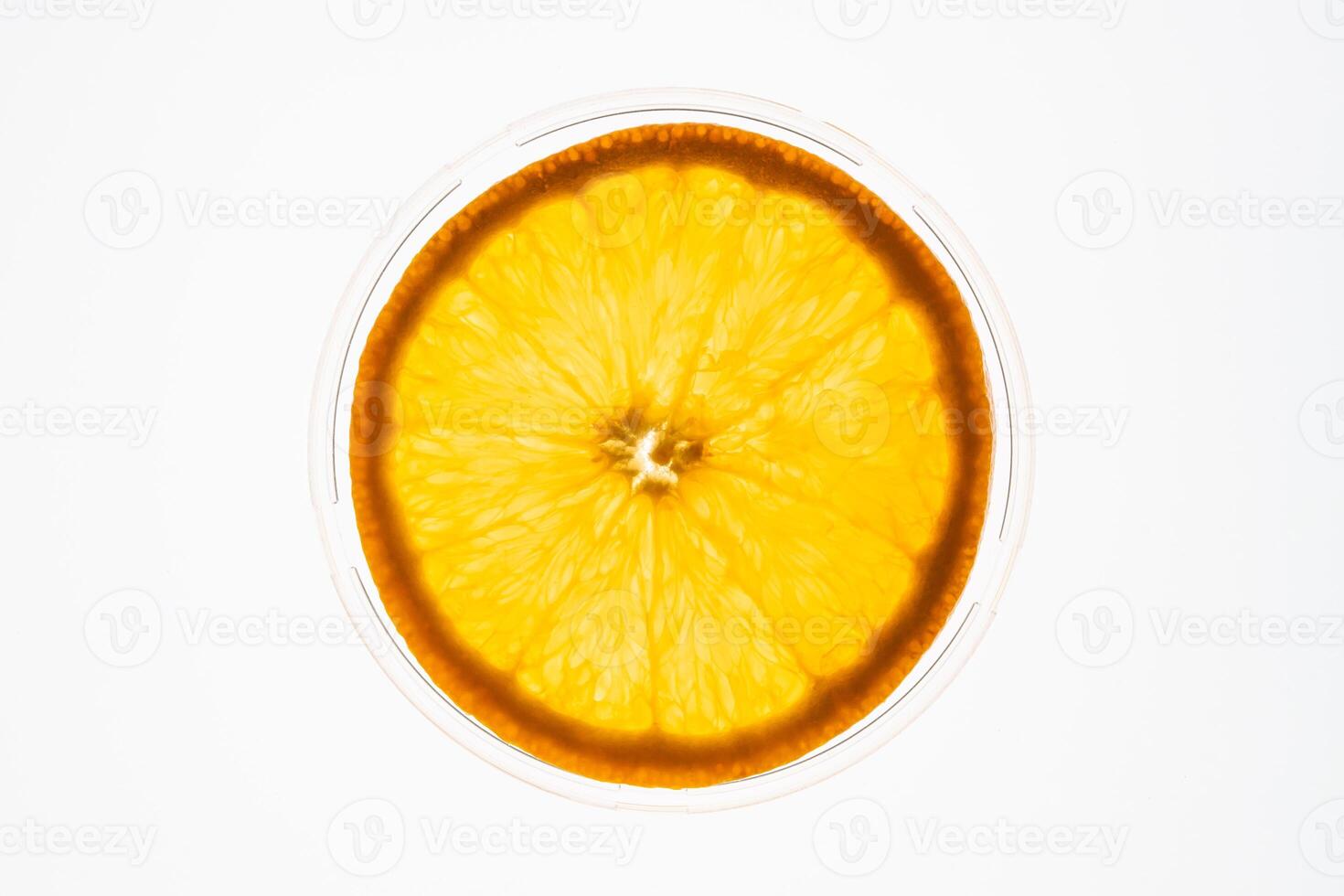 Slice of an orange isolated on white background back lit. Fruit concept photo