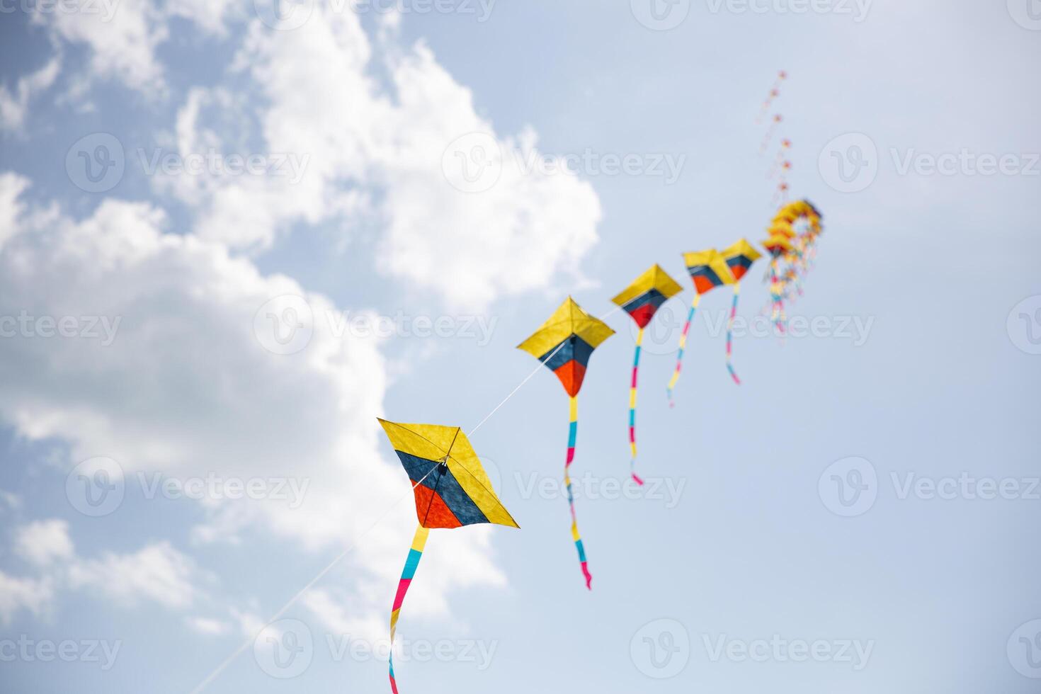 Colorful Kites in Sync flying photo