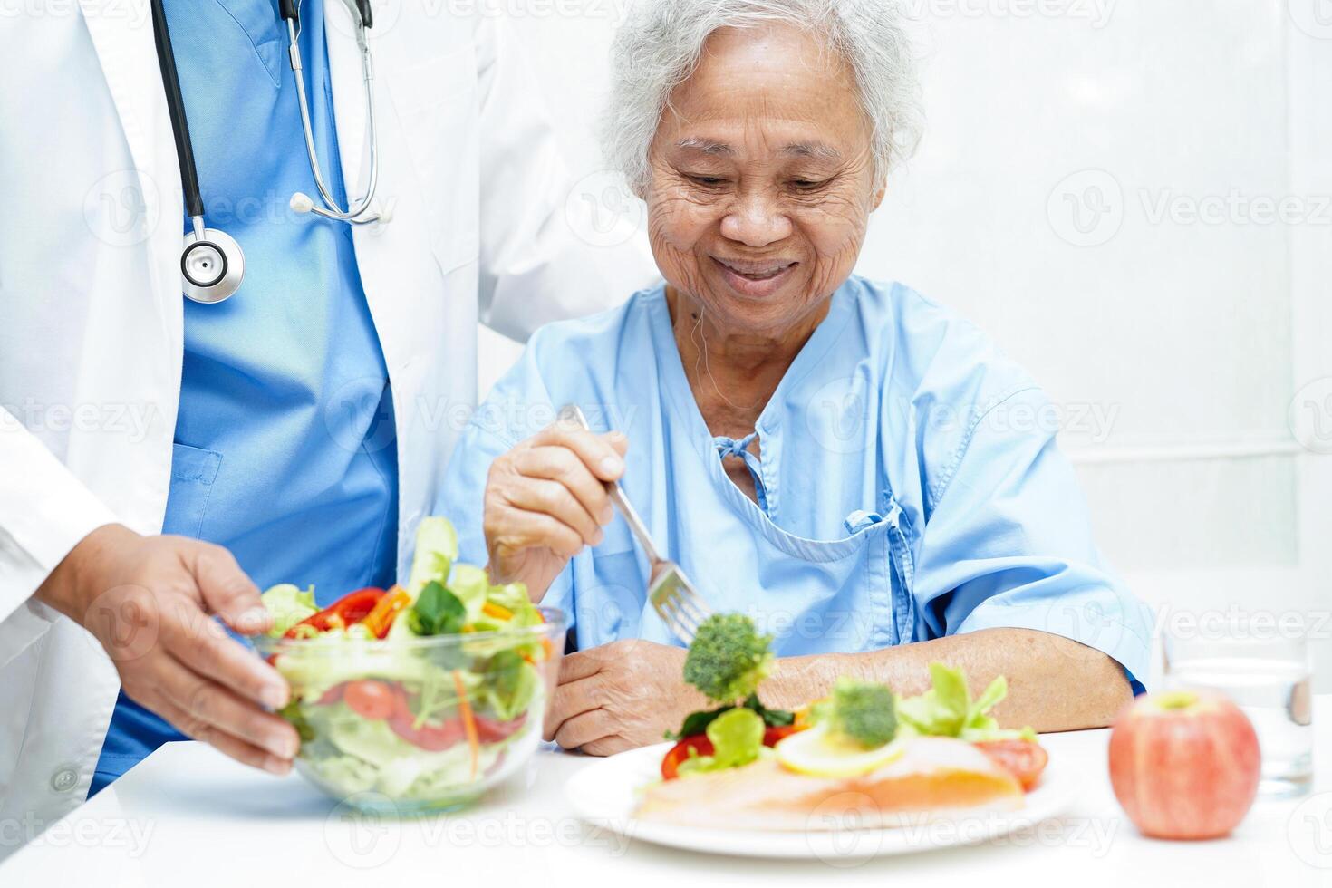 Asian Nutritionist holding healthy food for patient in hospital, nutrition and vitamin. photo
