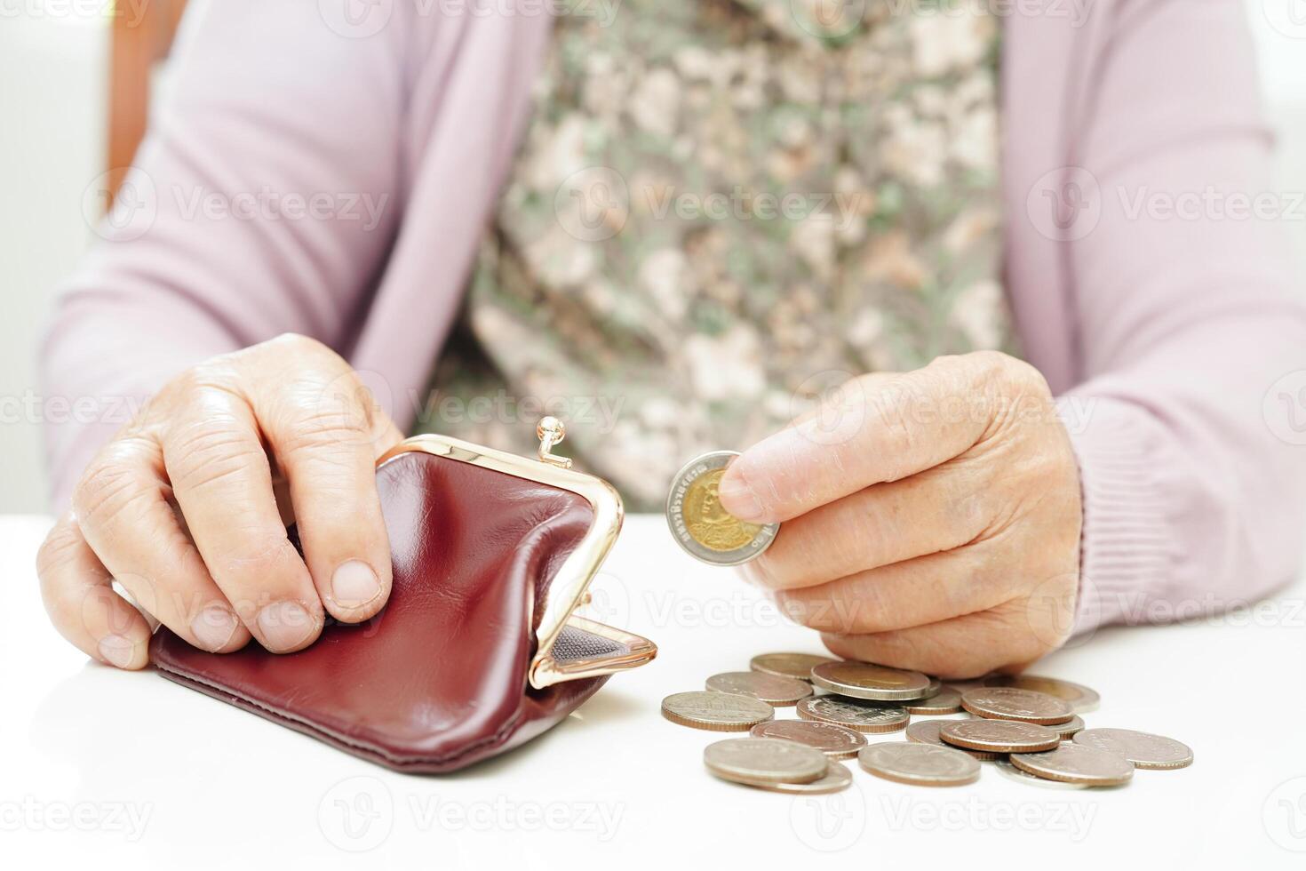 Retired elderly woman counting coins money and worry about monthly expenses and treatment fee payment. photo