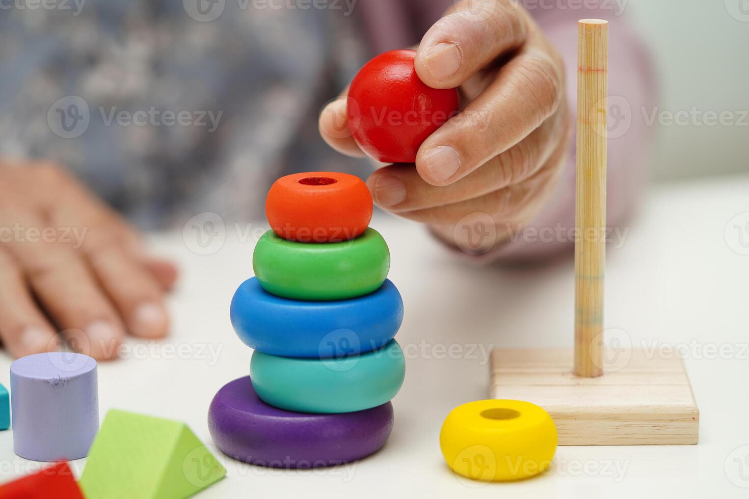Asian elderly woman playing puzzles game for treatment dementia prevention and Alzheimer disease. photo
