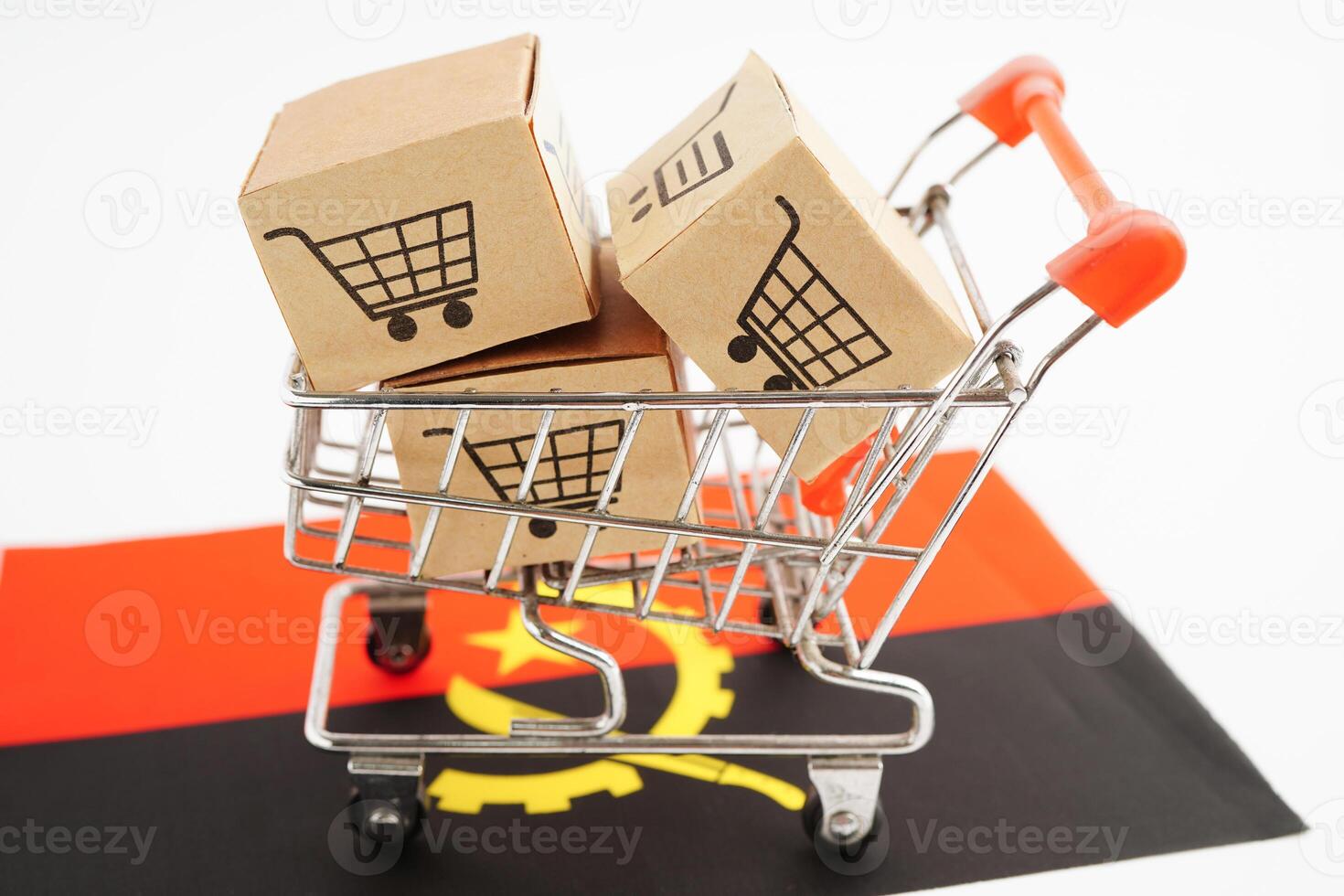 Online shopping, Shopping cart box on Angola flag, import export, finance commerce. photo