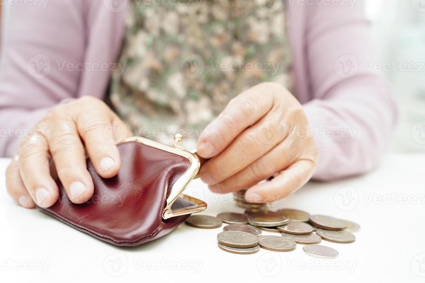 Retired elderly woman counting coins money and worry about monthly expenses and treatment fee payment. photo