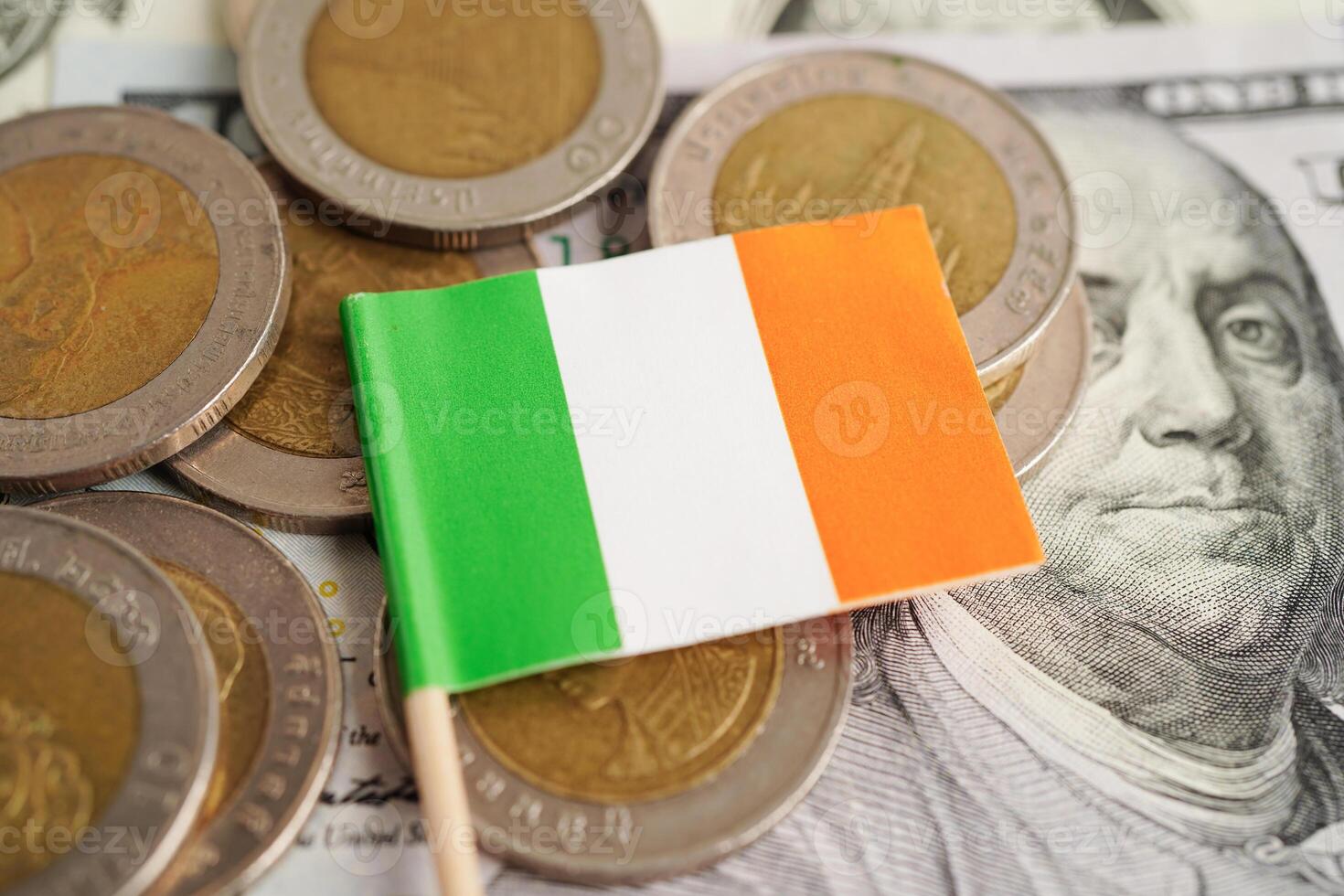 Ireland flag on coin and banknote money, finance trading investment business currency concept. photo