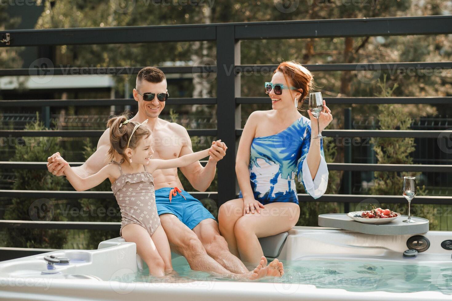In summer, the family rests in the outdoor hot tub photo