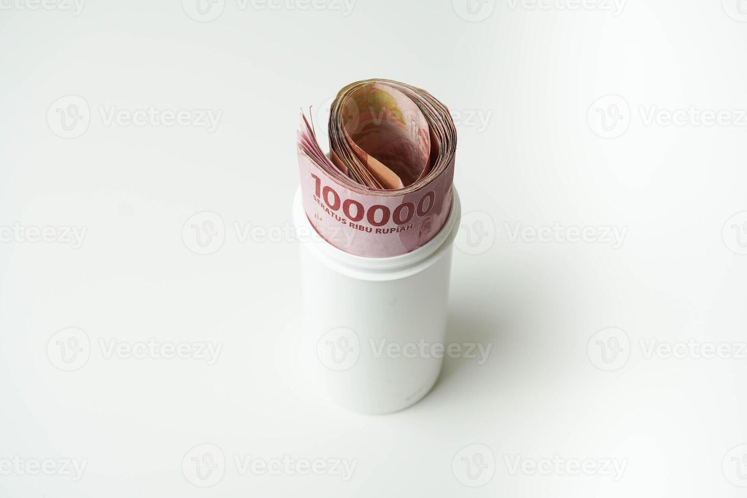 Indonesian money rupiah is in a white cup with a isolated white background photo