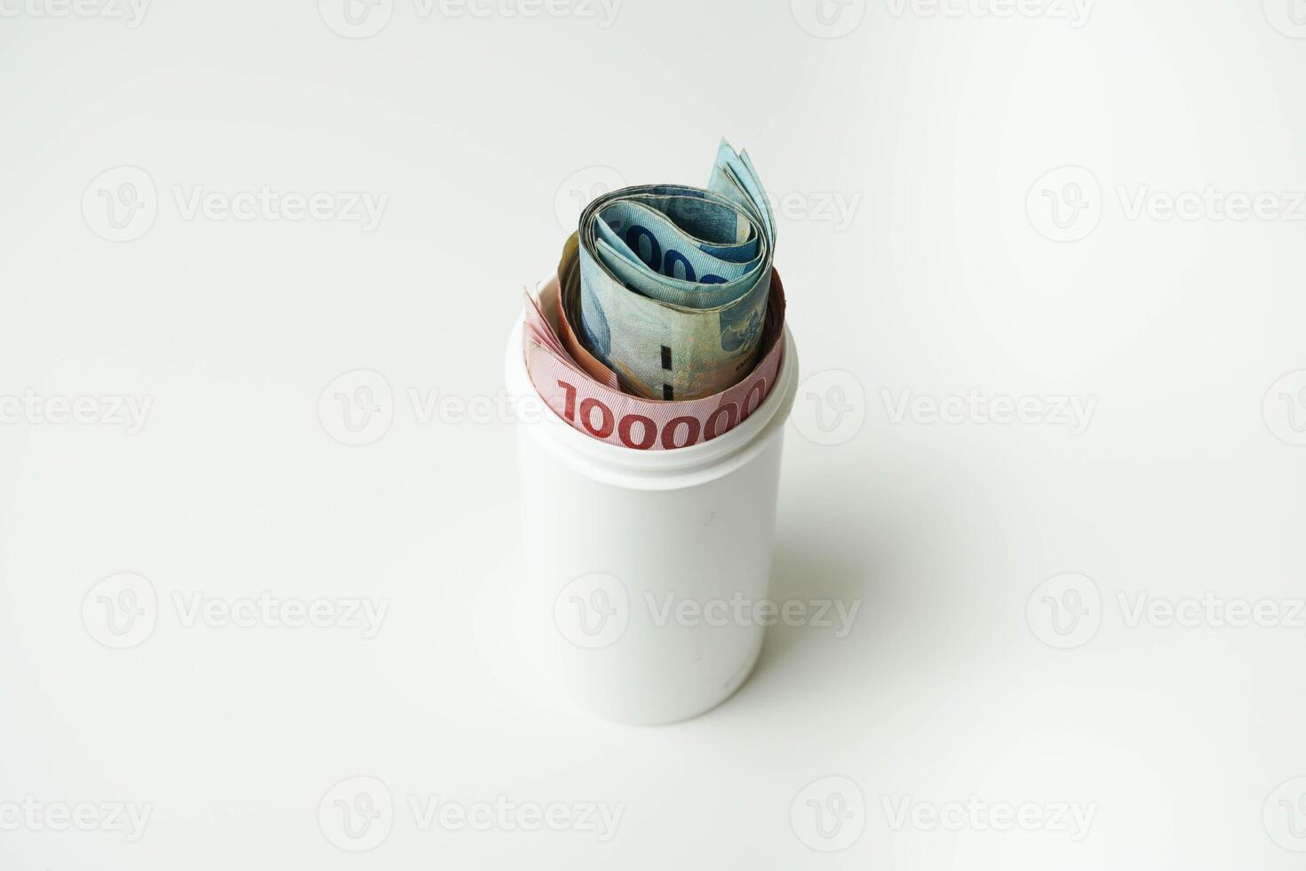 Indonesian money rupiah is in a white cup with a isolated white background photo