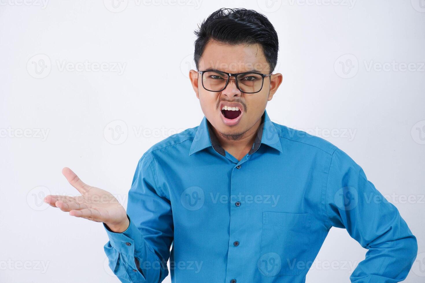 confused or amazed handsome young asian man with glasses in wearing shirt shrugging hands sideways and looking disappointed isolated on white background photo