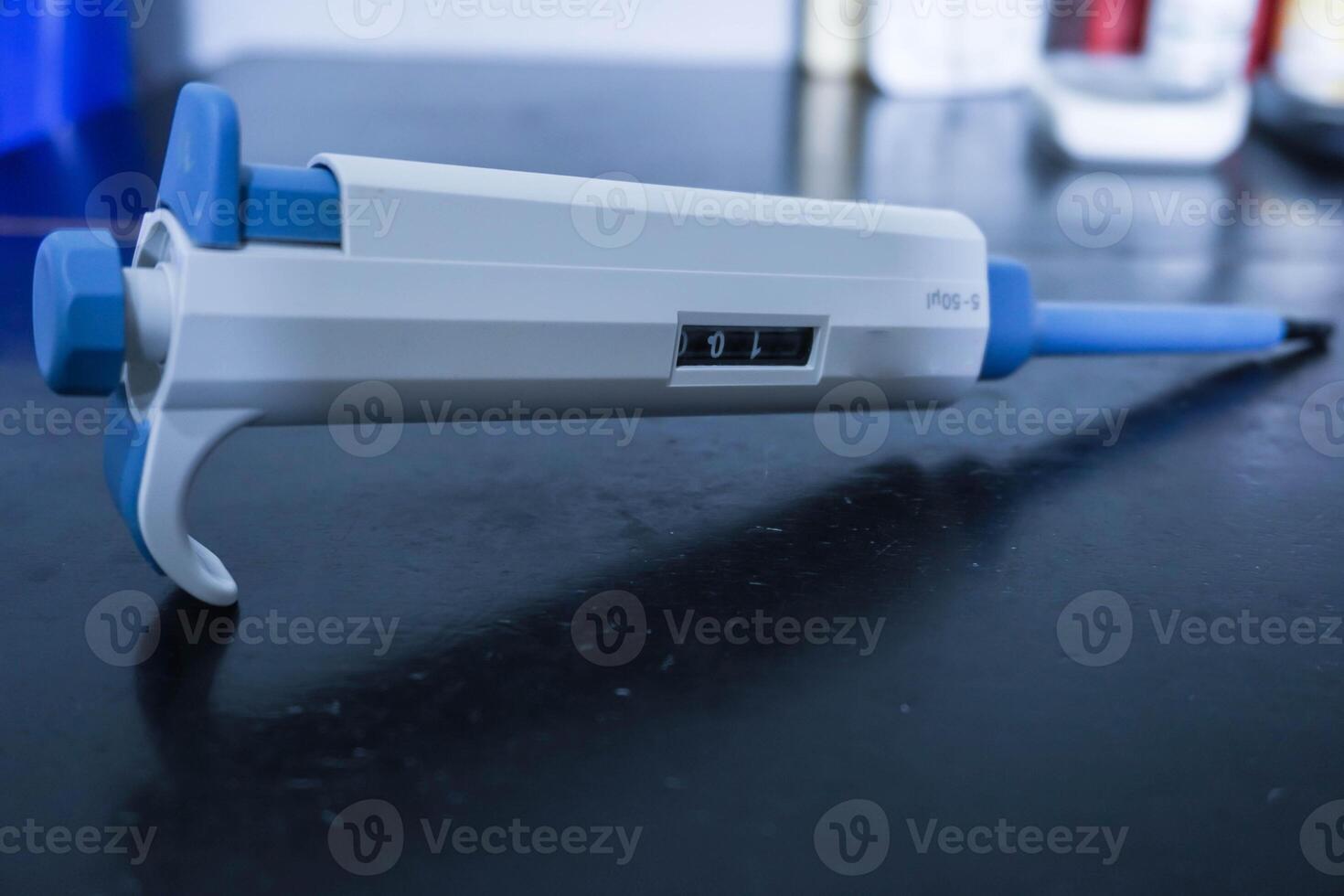 Automatic pipette, Micro pipettes, Micro chemical equipment laboratory Isolated on black table background photo