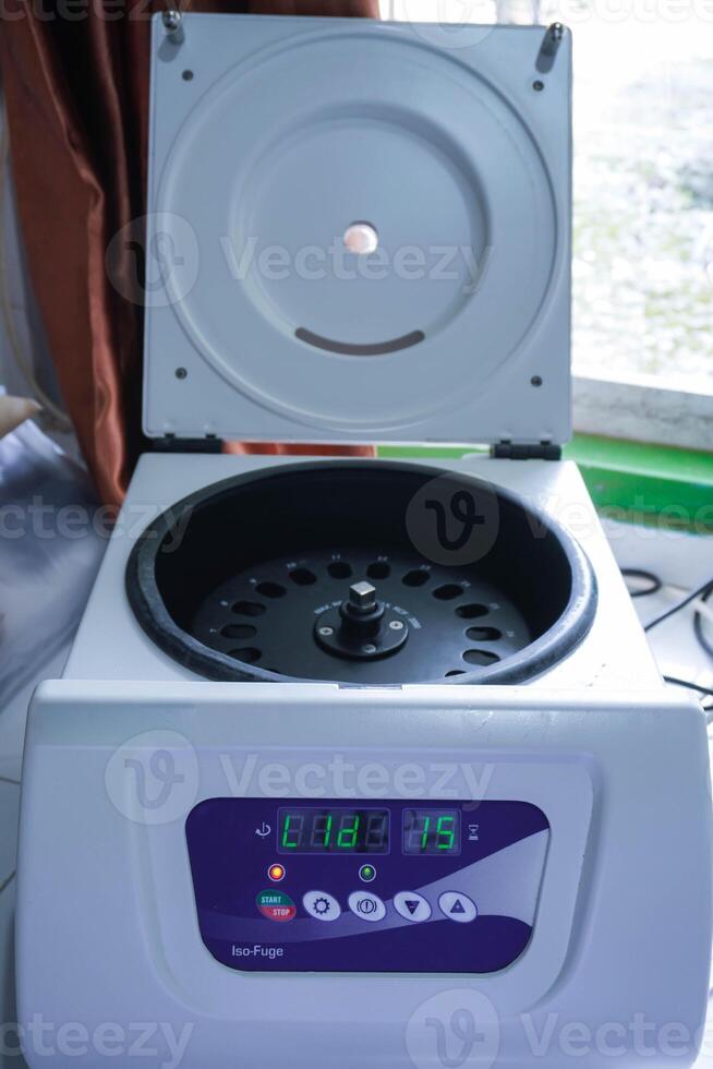 Laboratory equipment. Open laboratory centrifuge. White medical centrifuge with digital panel. Device for laboratory research. Modern lab technologies photo