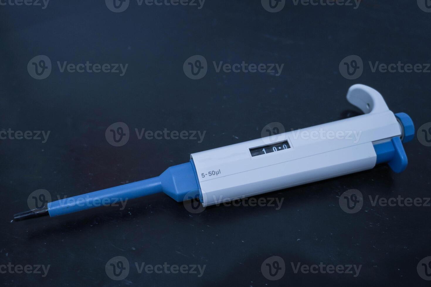 Automatic pipette, Micro pipettes, Micro chemical equipment laboratory Isolated on black table background photo