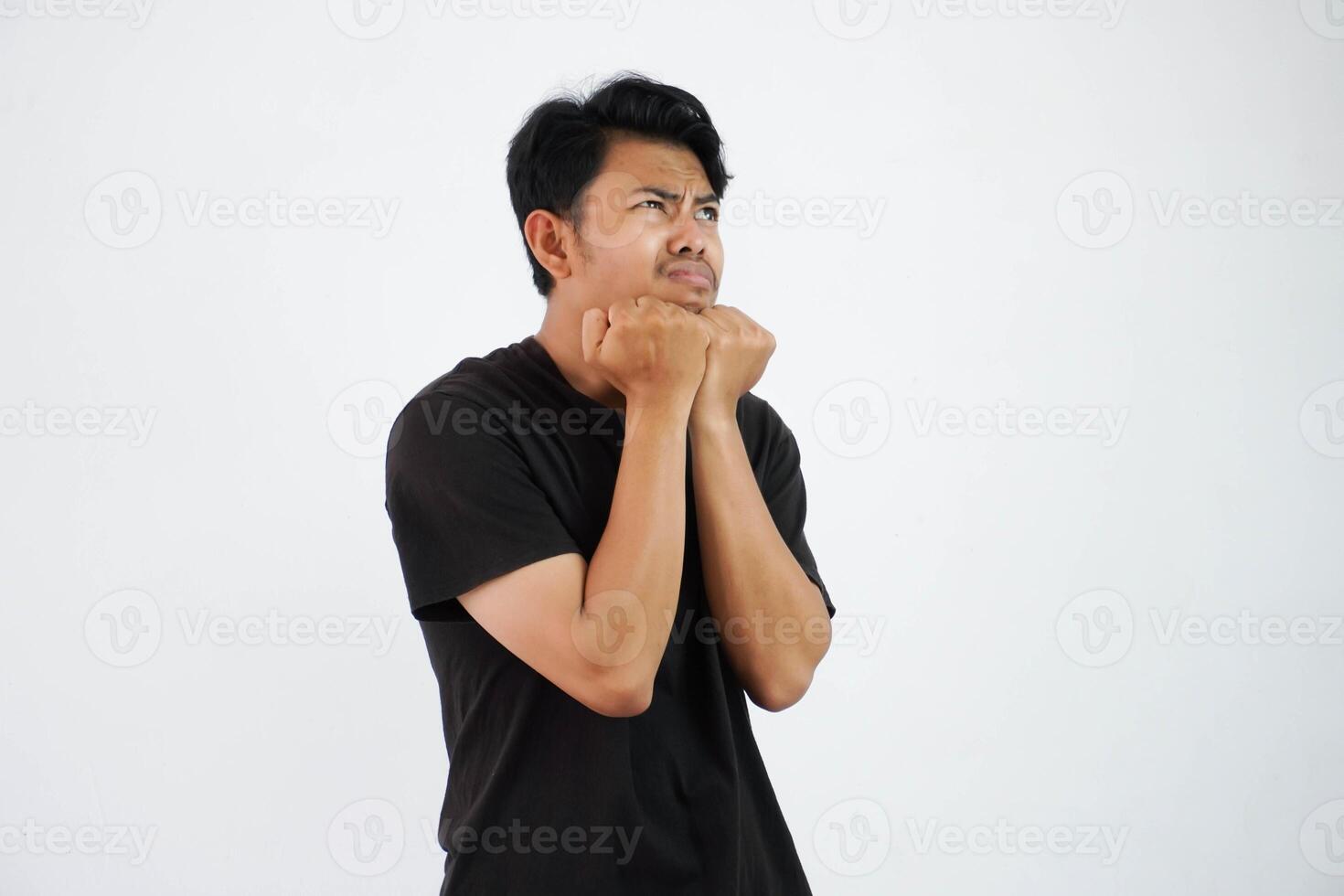 scared young Asian man black t shirt gesture afraid something isolated on white background photo