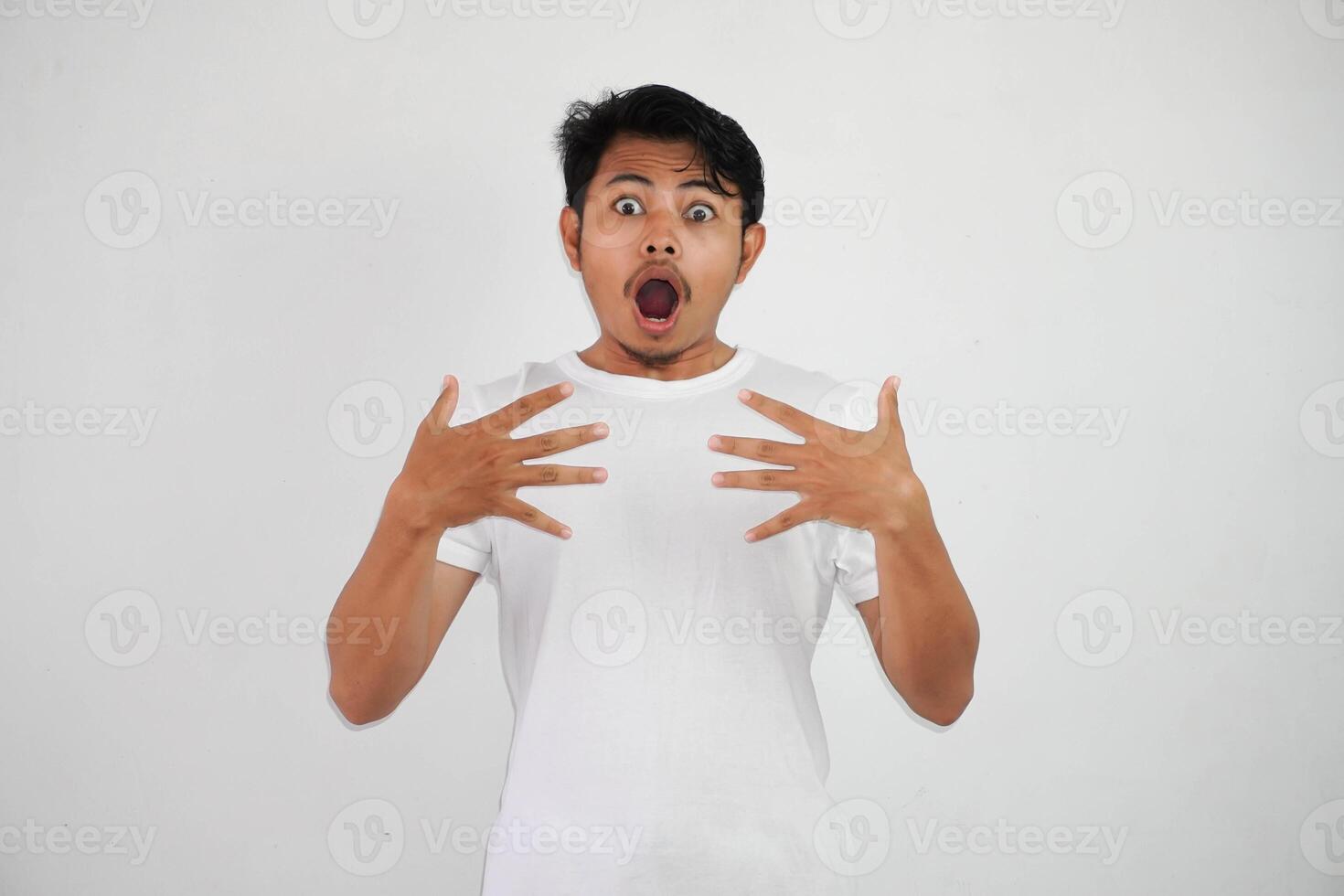 shock asian man with open hands and mouth wearing white t shirt isolated on white background photo