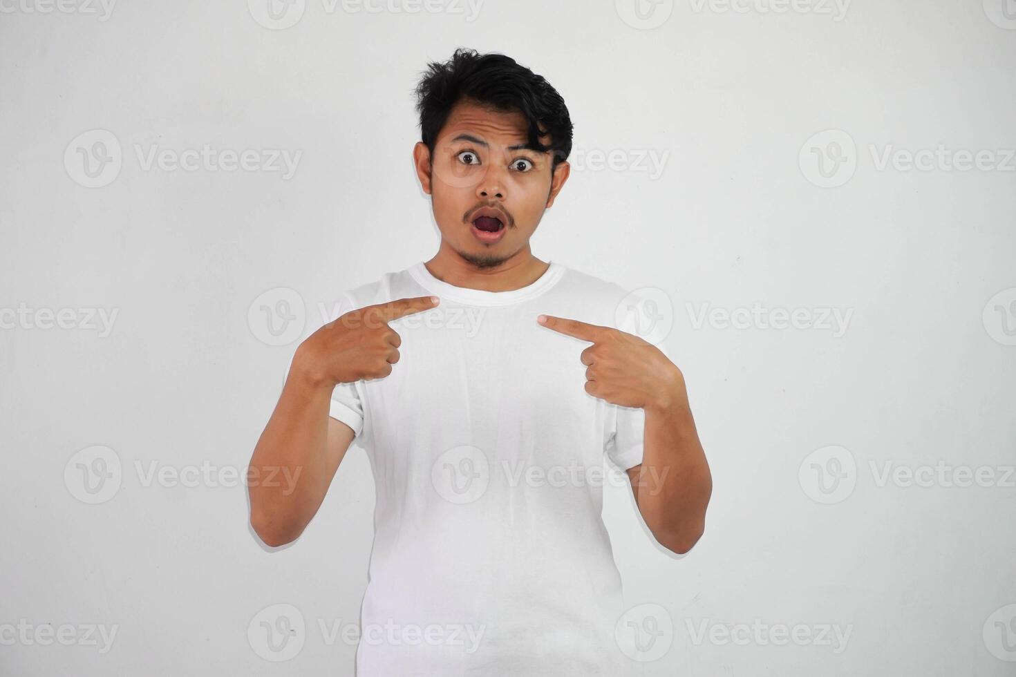 shocked or shouted young asian man Cheerful white t shirt excited point finger at himself open mouth isolated on white background photo