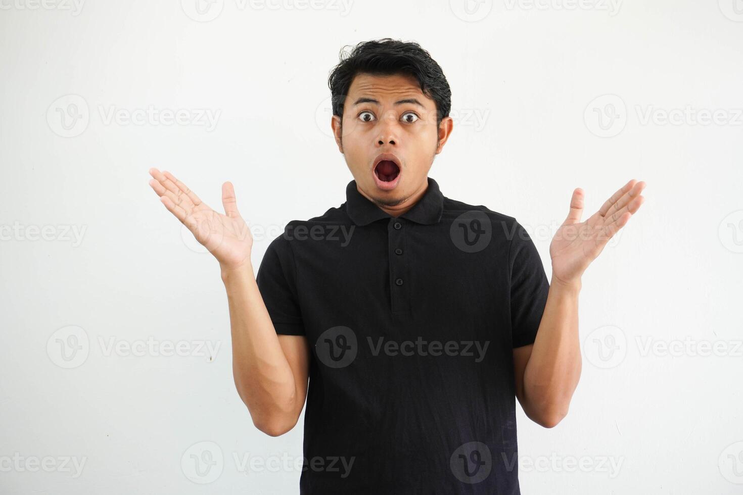 Amazed excited young asian man looking at camera with wow face expression feeling surprised advertising shopping promotion, unbelievable betting win standing isolated on white background. photo