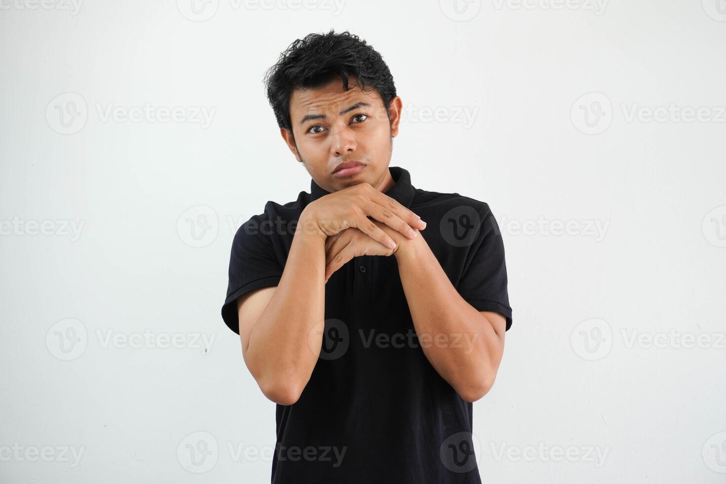 young asian man posing scared and afraid wearing black polo t shirt isolated on white background photo