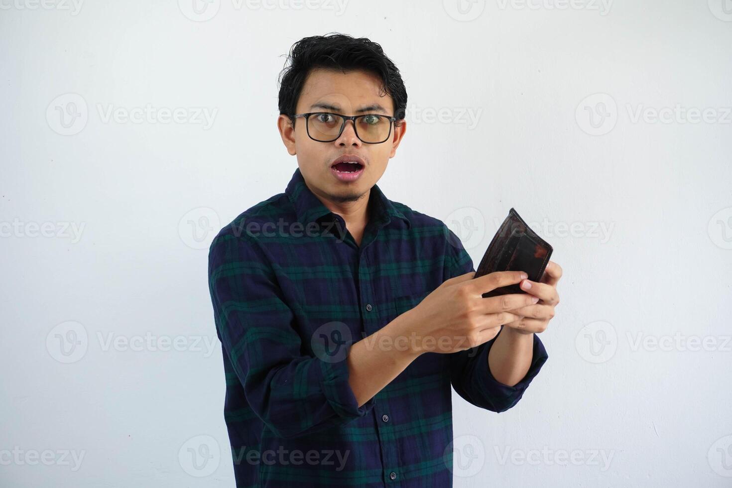 young asian man open his wallet and showing excited expression isolated on white background. photo